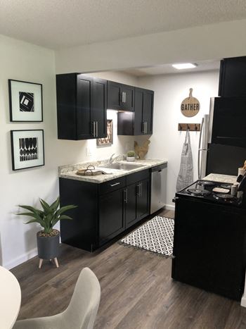 Kitchen with black cabinets and a sink and a counter top